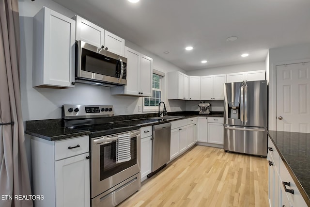133 Nebraska Ave, Oak Ridge, TN 37830 - kitchen with appliances with stainless steel finishes, a sink, light wood finished floors, recessed lighting, and white cabinetry