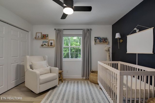 133 Nebraska Ave, Oak Ridge, TN 37830 - bedroom featuring wood finished floors, a crib, a closet, ceiling fan, and baseboards
