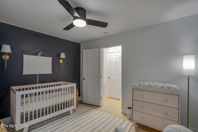 133 Nebraska Ave, Oak Ridge, TN 37830 - bedroom featuring wood finished floors, a nursery area, a ceiling fan, and baseboards