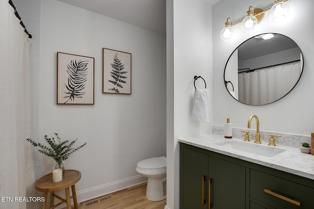 133 Nebraska Ave, Oak Ridge, TN 37830 - full bath with wood finished floors, toilet, and vanity