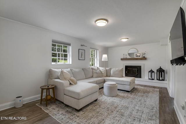 133 Nebraska Ave, Oak Ridge, TN 37830 - living area with wood finished floors, ornamental molding, baseboards, and a brick fireplace