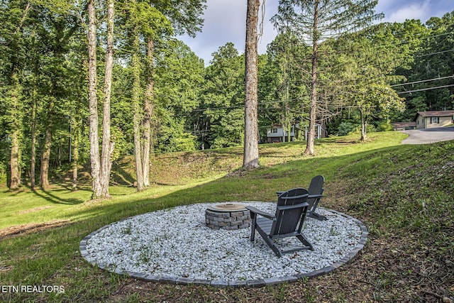 133 Nebraska Ave, Oak Ridge, TN 37830 - view of green lawn with an outdoor fire pit and a wooded view