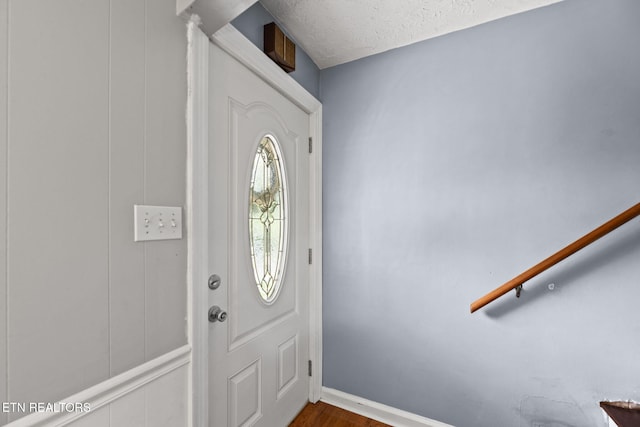 313 Lamar Ave, Clinton, TN 37716 - foyer featuring dark wood finished floors, baseboards, and a textured ceiling