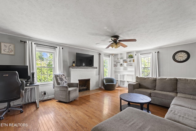 313 Lamar Ave, Clinton, TN 37716 - living room with hardwood / wood-style flooring, plenty of natural light, a fireplace, crown molding, and a textured ceiling