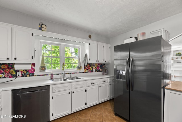 313 Lamar Ave, Clinton, TN 37716 - kitchen featuring appliances with stainless steel finishes, a sink, white cabinetry, tile patterned floors, and light countertops