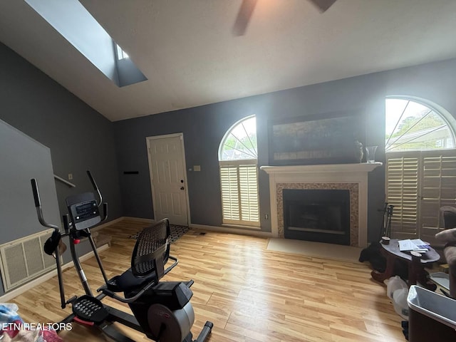 119 Hanover Pl, Oak Ridge, TN 37830 - exercise room with wood finished floors, lofted ceiling, a skylight, and a fireplace with flush hearth
