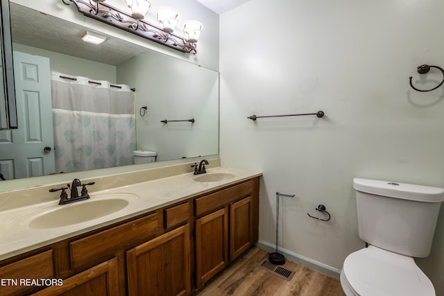 119 Hanover Pl, Oak Ridge, TN 37830 - bathroom with toilet, wood finished floors, double vanity, baseboards, and a shower with curtain