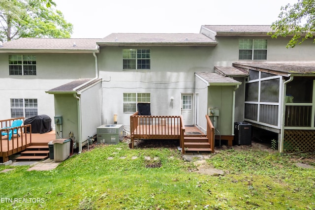 119 Hanover Pl, Oak Ridge, TN 37830 - back of property with stucco siding, a deck, a lawn, and central AC