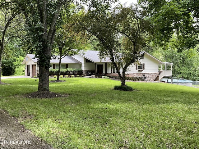 view of front of house with a front lawn, stone siding, and stairway