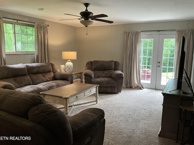 living room featuring carpet floors, plenty of natural light, a ceiling fan, and french doors