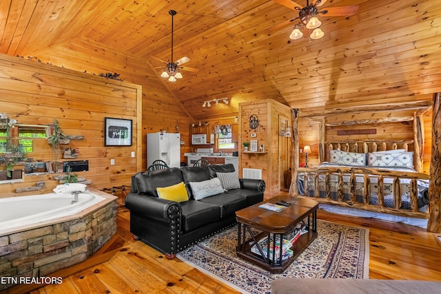 living room with ceiling fan, lofted ceiling, wooden walls, wood-type flooring, and wooden ceiling