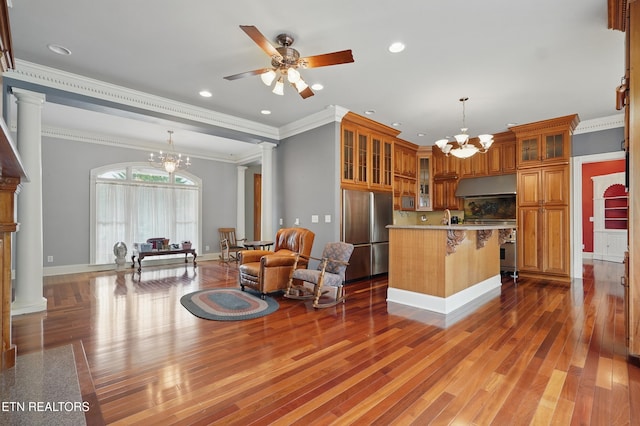 6005 Powell Valley Rd, Big Stone Gap, VA 24219 - kitchen featuring stainless steel appliances, a chandelier, brown cabinetry, light wood-style flooring, and ornate columns