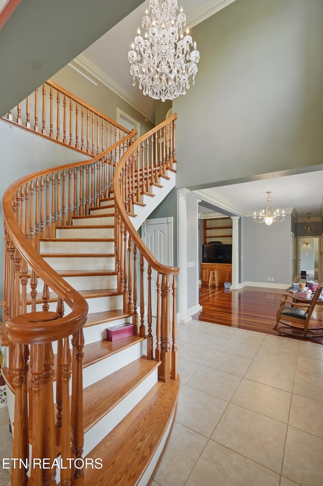 6005 Powell Valley Rd, Big Stone Gap, VA 24219 - staircase with a chandelier, tile patterned flooring, a high ceiling, crown molding, and baseboards