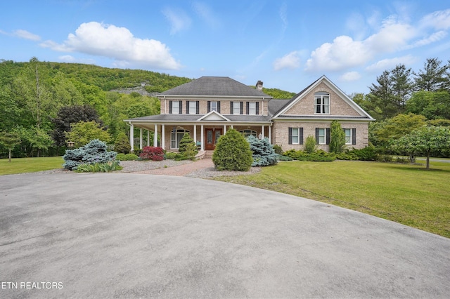 6005 Powell Valley Rd, Big Stone Gap, VA 24219 - view of front of home with a porch, a front lawn, a chimney, and brick siding