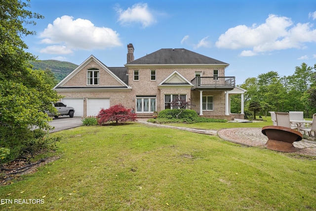 6005 Powell Valley Rd, Big Stone Gap, VA 24219 - rear view of property featuring a balcony, brick siding, driveway, a yard, and a chimney