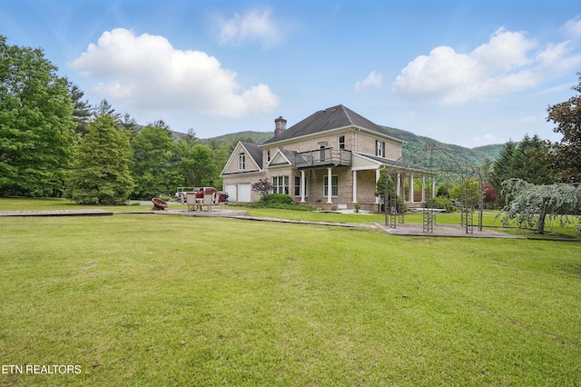 6005 Powell Valley Rd, Big Stone Gap, VA 24219 - view of front facade featuring a chimney, a front yard, a balcony, and a mountain view