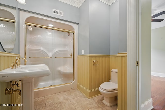 6005 Powell Valley Rd, Big Stone Gap, VA 24219 - full bathroom with wainscoting, a stall shower, toilet, crown molding, and tile patterned flooring