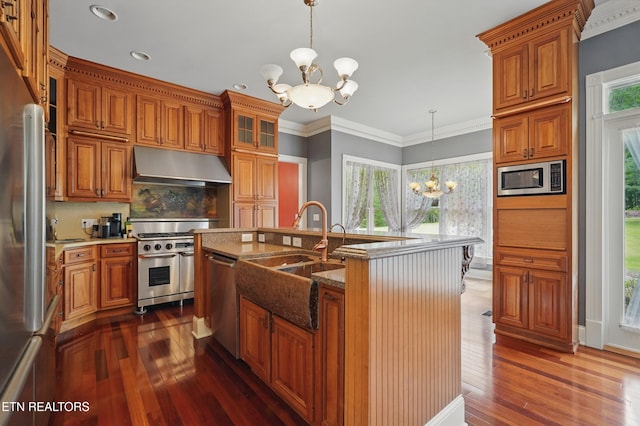 6005 Powell Valley Rd, Big Stone Gap, VA 24219 - kitchen featuring under cabinet range hood, a chandelier, appliances with stainless steel finishes, brown cabinets, and recessed lighting