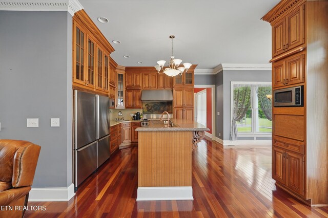 6005 Powell Valley Rd, Big Stone Gap, VA 24219 - kitchen featuring stainless steel appliances, baseboards, under cabinet range hood, brown cabinetry, and recessed lighting