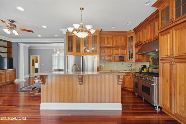 6005 Powell Valley Rd, Big Stone Gap, VA 24219 - kitchen with stainless steel appliances, under cabinet range hood, brown cabinetry, a sink, and a chandelier