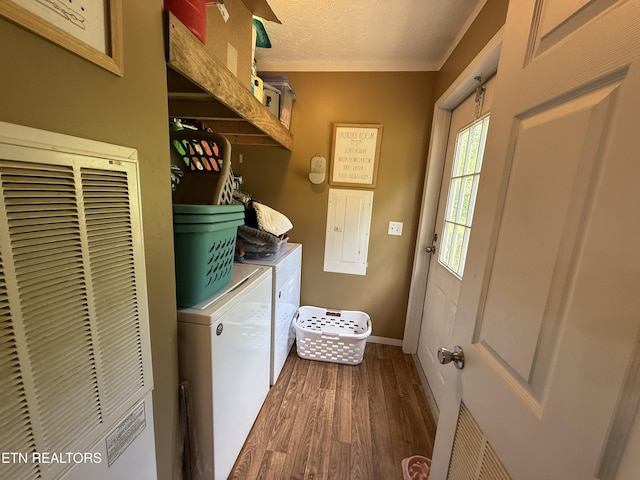 332 Tomlinson Rd, Pennington Gap, VA 24277 - laundry area featuring washing machine and dryer, dark wood-type flooring, a heating unit, baseboards, and crown molding