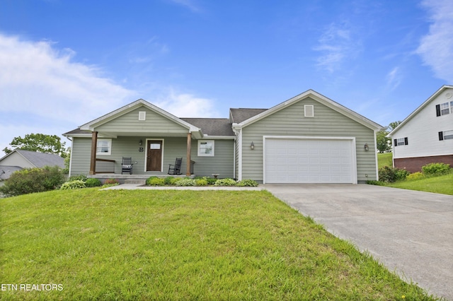 view of front of house featuring covered porch, a garage, a front yard, and concrete driveway