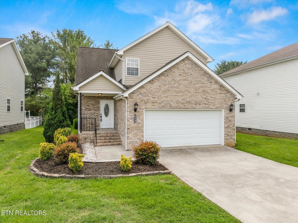 608 Lynnwood Dr, Athens, TN 37303 - view of front of home with brick siding, a front lawn, driveway, and a garage