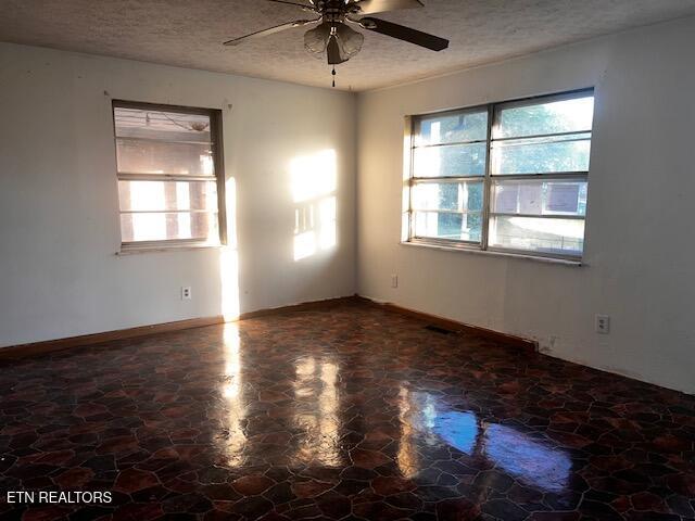 867 Pleasant Ridge Rd, Lafollette, TN 37766 - empty room with ceiling fan and a textured ceiling