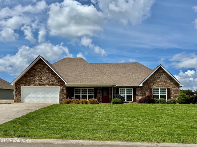 1617 Millstone Dr, Maryville, TN 37803 - view of front of house with a shingled roof, an attached garage, a front yard, and driveway