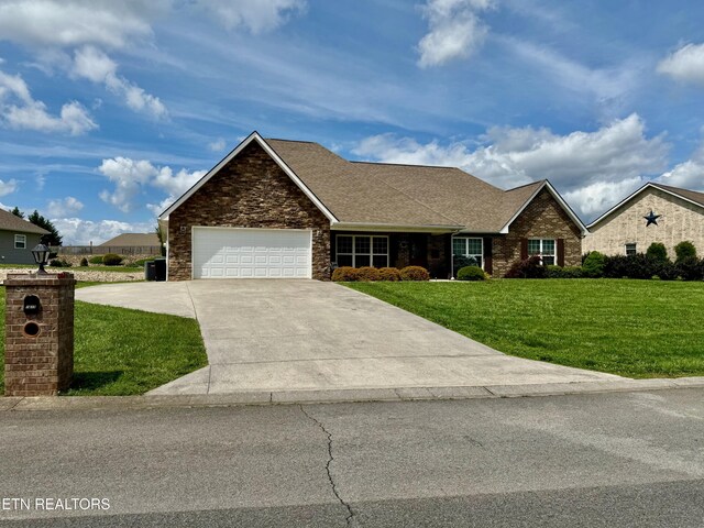 1617 Millstone Dr, Maryville, TN 37803 - view of front facade featuring a front yard, a garage, driveway, a shingled roof, and stone siding