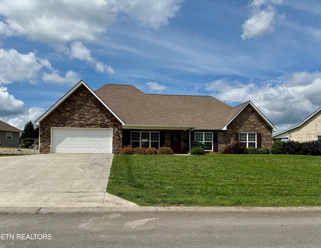 1617 Millstone Dr, Maryville, TN 37803 - view of front of house with concrete driveway, a front yard, a garage, roof with shingles, and stone siding