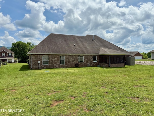 1617 Millstone Dr, Maryville, TN 37803 - rear view of house with a sunroom, a yard, brick siding, and roof with shingles