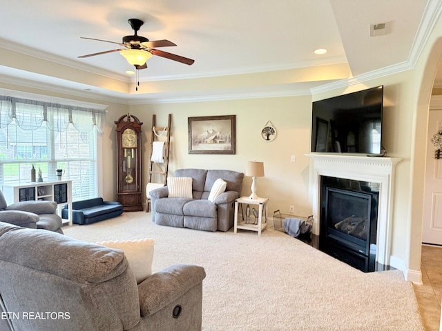 1617 Millstone Dr, Maryville, TN 37803 - living room with a tray ceiling, a glass covered fireplace, ornamental molding, a ceiling fan, and carpet flooring