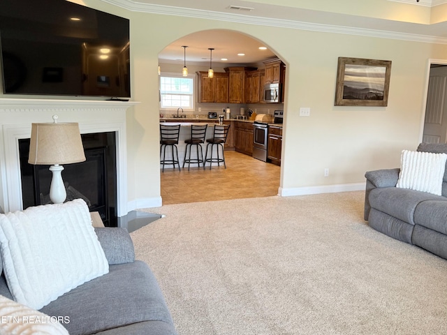 1617 Millstone Dr, Maryville, TN 37803 - living room featuring arched walkways, crown molding, light colored carpet, baseboards, and a fireplace with flush hearth