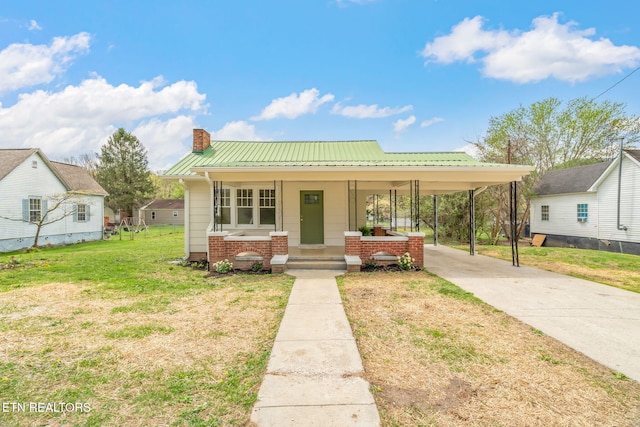 406 S Indiana Ave, Lafollette, TN 37766 - view of front of property featuring concrete driveway, a chimney, a front yard, a carport, and a porch