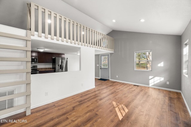 518 Church St, Vonore, TN 37885 - unfurnished living room with wood finished floors, baseboards, and high vaulted ceiling