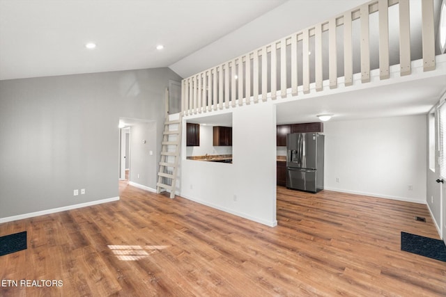 518 Church St, Vonore, TN 37885 - unfurnished living room featuring high vaulted ceiling, baseboards, and light wood-type flooring