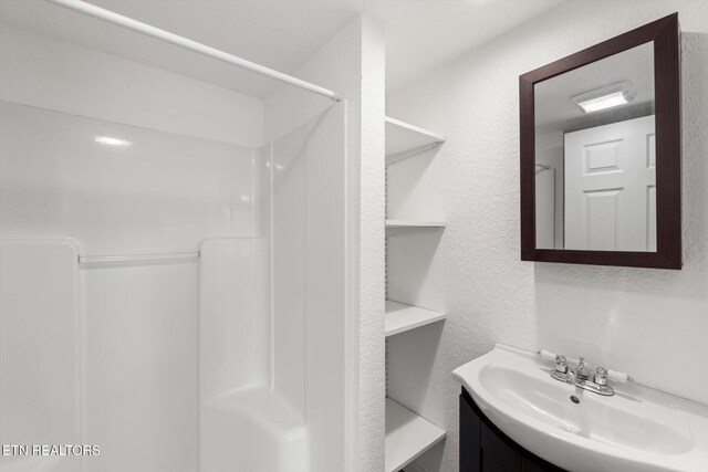 518 Church St, Vonore, TN 37885 - bathroom featuring vanity, a shower, and a textured wall