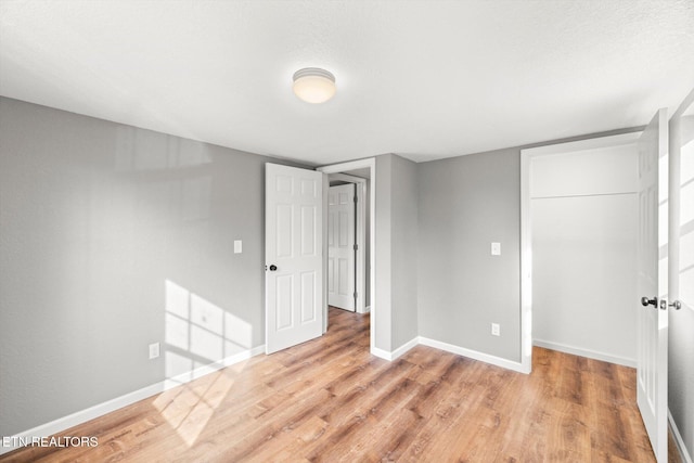 518 Church St, Vonore, TN 37885 - unfurnished bedroom with baseboards, light wood finished floors, and a closet