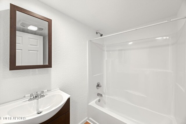 518 Church St, Vonore, TN 37885 - bathroom featuring a textured wall, shower / bathtub combination, and vanity