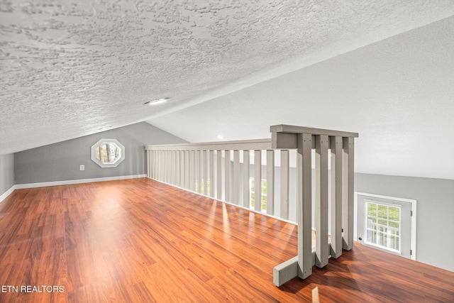 518 Church St, Vonore, TN 37885 - bonus room featuring lofted ceiling, wood finished floors, a textured ceiling, and baseboards