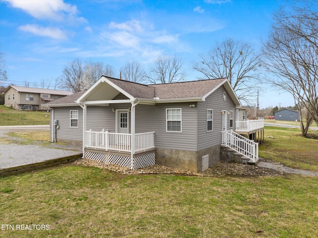 518 Church St, Vonore, TN 37885 - back of property with a yard, roof with shingles, and a deck