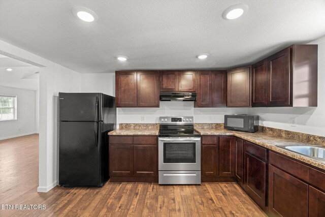 522 Church St, Vonore, TN 37885 - kitchen featuring black appliances, under cabinet range hood, dark wood-style flooring, recessed lighting, and dark brown cabinets