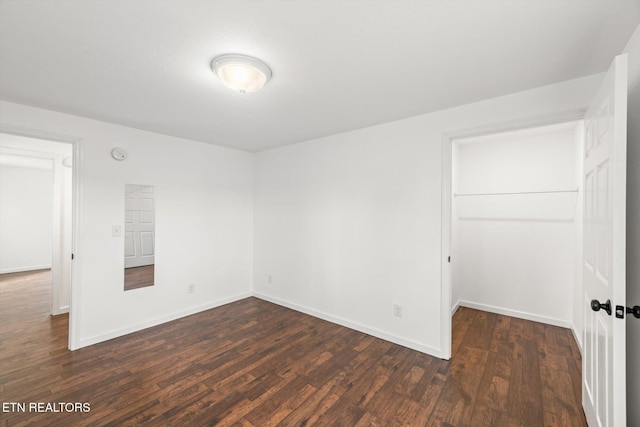 522 Church St, Vonore, TN 37885 - unfurnished bedroom with dark wood-type flooring, baseboards, a closet, and a walk in closet