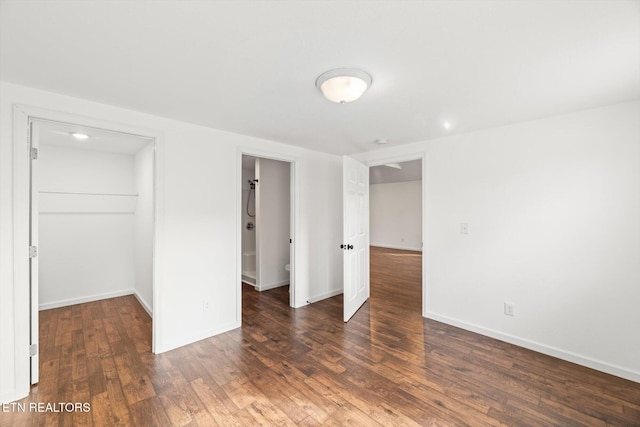 522 Church St, Vonore, TN 37885 - unfurnished bedroom with a spacious closet, wood finished floors, a closet, and baseboards