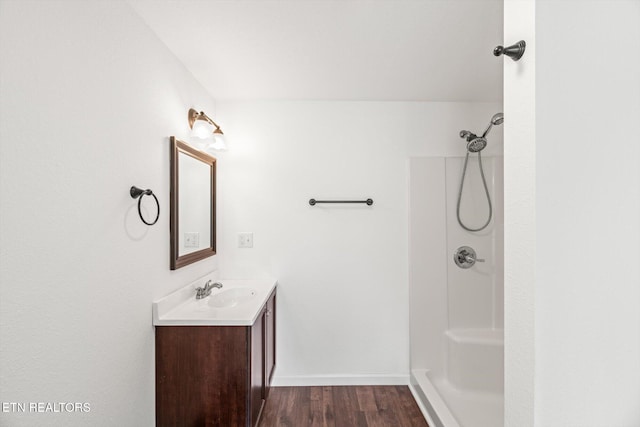 522 Church St, Vonore, TN 37885 - bathroom with vanity, a shower, wood finished floors, and baseboards