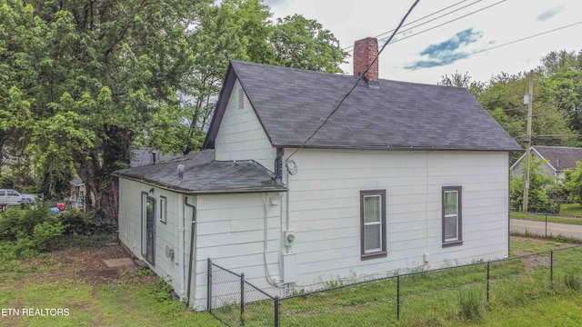 2918 Johnston St, Knoxville, TN 37921 - view of home's exterior featuring a chimney, roof with shingles, and fence