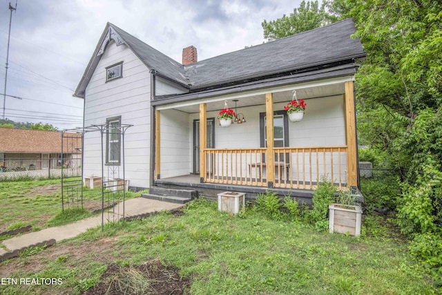 2918 Johnston St, Knoxville, TN 37921 - view of front of property with a porch, a chimney, roof with shingles, and fence