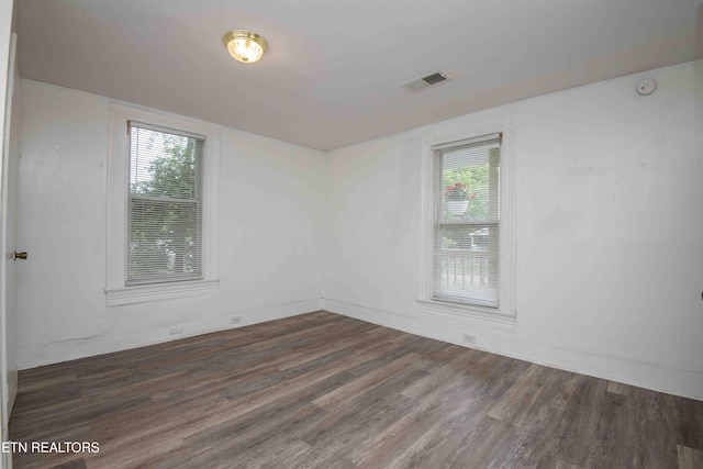 2918 Johnston St, Knoxville, TN 37921 - empty room with wood finished floors, plenty of natural light, and baseboards