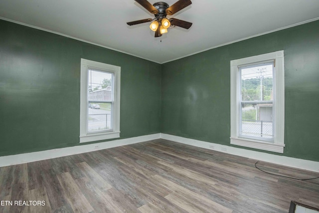 2918 Johnston St, Knoxville, TN 37921 - spare room featuring crown molding, wood finished floors, ceiling fan, and baseboards